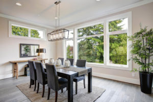 Modern dining room with budget-friendly EcoTek 2200 Series Double-Pane Windows by WinTek USA for energy efficiency and style.