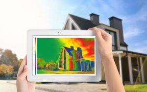 Infrared image of a home showing energy loss, taken on a tablet for energy-efficient home improvements