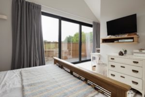sliding patio doors with black frames in a bedroom