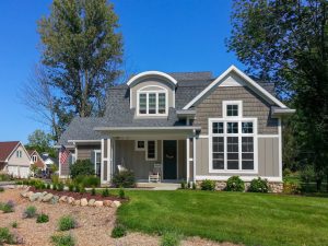 attractive home with gray siding and large attractive windows