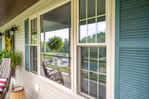 bay windows on the front of a home facing a porch