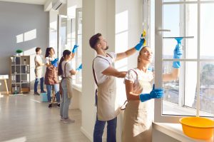 Team of professionals cleaning EcoTek windows indoors, following maintenance tips to ensure energy efficiency and longevity.